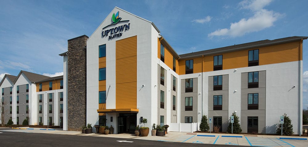 Uptown Suites hotel exterior with accessible parking spaces