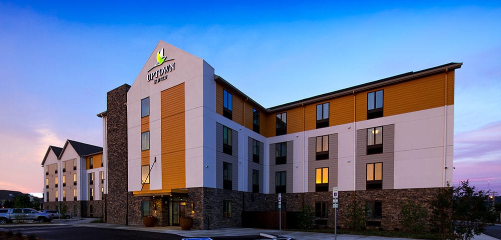 Uptown Suites hotel exterior at dusk