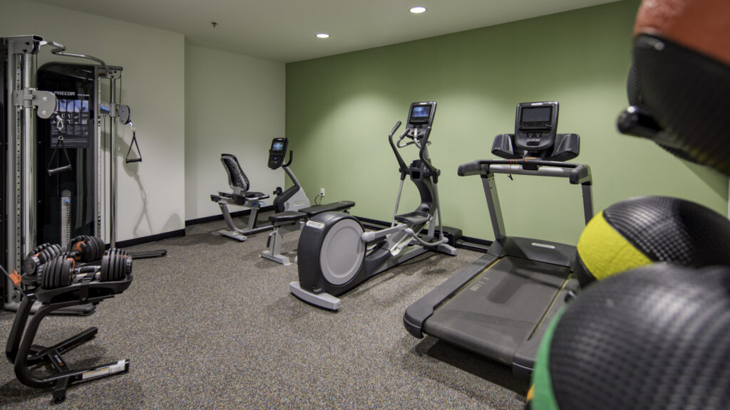 Hotel fitness room with cardio equipment and medicine balls