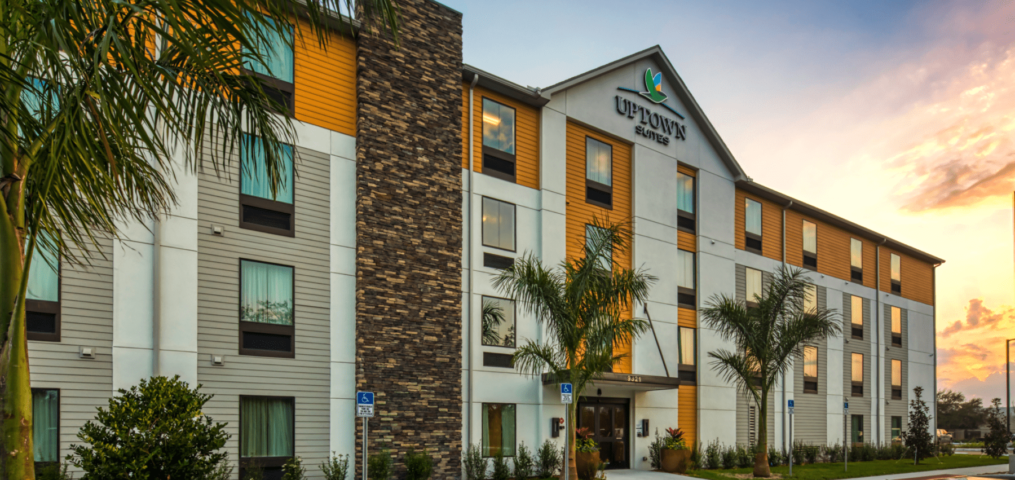 Uptown Suites hotel exterior with palm trees